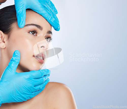 Image of Woman, plastic surgery and gloves on face in studio, check and cosmetics with mockup space by background. Young girl, model and surgeon hands with thinking, inspection and measurement for aesthetic