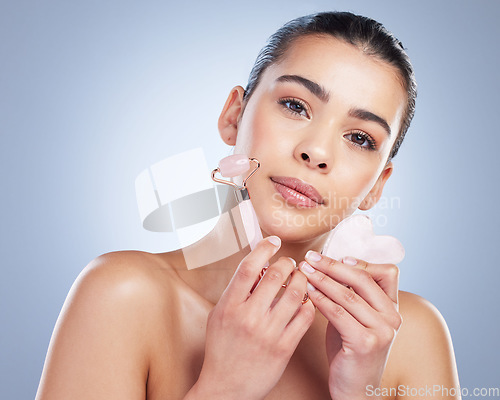 Image of Beauty, facial roller and skin portrait of a woman in studio with skincare tools for natural glow. Face of a female aesthetic model on a gradient background for shine, cosmetics and self care massage