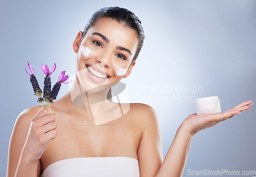 Image of Beauty, cream and woman with lavender flower in studio for skincare product and natural glow. Portrait of happy female model on a gradient background for facial shine, cosmetics and face moisturizer