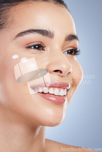 Image of Skincare, beauty and happy woman with face cream application in studio for beauty, wellness or care on grey background. Sunscreen, smile and asian female model relax with luxury hydration facial mask