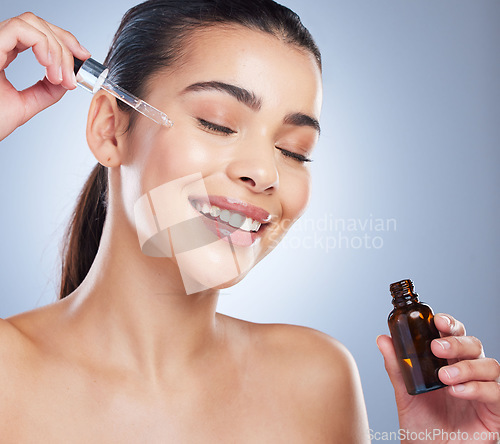 Image of Skincare, oil serum and face of woman in studio for wellness, health and product. Dermatology aesthetic, salon and female with liquid pipette, vial or dropper for moisturizer, cosmetics and beauty