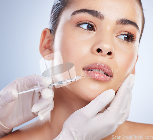 Image of Syringe, woman and plastic surgery with skincare, collagen and beauty against a studio background. Female person, girl or model with a needle, cosmetics or body transformation with aesthetic and care