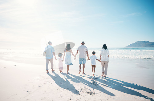 Image of Travel, beach and family walking on sand together at the sea or ocean bonding for love, care and happiness. Happy, sun and parents with children or kids and grandparents on a holiday for freedom