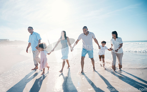 Image of Water, beach and big family together on holiday at the sea or ocean bonding for love, care and happiness. Happy, sun and parents with children or kids and grandparents on a vacation for freedom