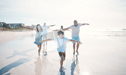 Image of Fly, beach and happy family running or playing together at the sea or ocean bonding for love, care and happiness. Summer, sun and parents with children or kids and grandparents on holiday for freedom