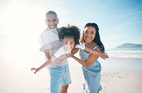 Image of Beach, portrait and parents flying their kid on the sand by the ocean on a family vacation. Happy, smile and girl child playing and bonding with her young mother and father on tropical summer holiday