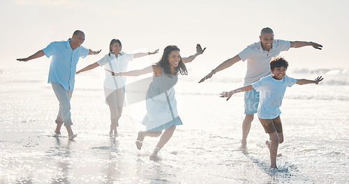 Image of Travel, beach and happy family running together at the sea or ocean bonding for love, care and happiness. Summer, sun and parents with children or kids and grandparents on a holiday for freedom