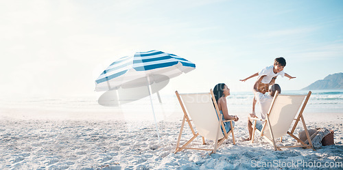 Image of Beach, travel and family relaxing while on a vacation, adventure or weekend trip for summer. Freedom, bonding and father flying his boy child sitting by the ocean with his wife on a tropical holiday.