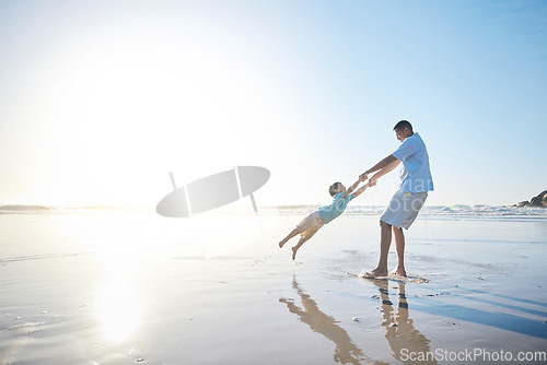 Image of Family, father and spinning a child at the beach for fun, adventure and play on holiday. A man and young kid holding hands on vacation at the ocean, nature or outdoor with mockup banner space in sky