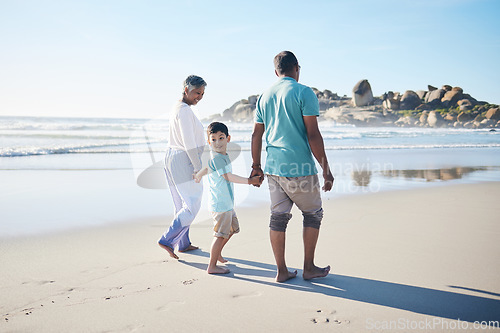 Image of Beach, walking and grandparents holding hands with child for bonding, quality time and relax in nature. Family, retirement and happy elderly man and woman with boy on holiday, vacation and travel