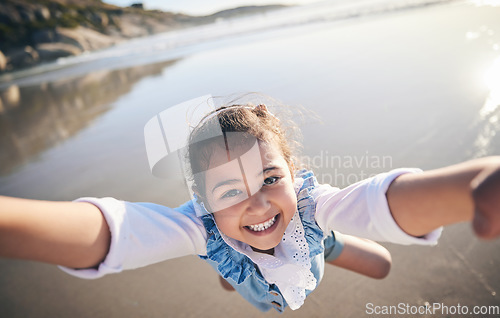 Image of Person, spinning girl and pov at beach, portrait and smile for game, excited face and playing by sea in sunshine. Parent, young child and swing with speed, love or bonding with holding hands by ocean