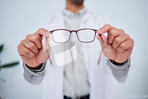 Image of Hands, person and optometrist with glasses for vision, eyesight and prescription eye care. Closeup of doctor, optician and frame of lens, eyewear test and consulting for optical healthcare assessment