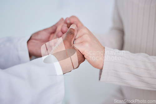 Image of Closeup, holding hands and doctor with a patient, support or cancer with treatment, healthcare or empathy. Zoom, medical professional or woman with test results, consulting or help with hope or trust