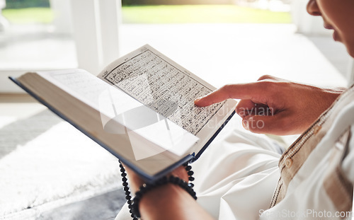 Image of Reading book, Islamic or hands of man with Quran on Eid Mubarak praying to God or worship at home. Allah, hope or Ramadan with spiritual person learning Muslim info for faith, religion and gratitude