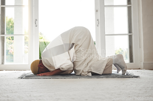 Image of Prayer, muslim and islamic with man on living room floor for eid mubarak, God and worship. Quran, hope and Ramadan with spiritual person praying on mat at home for faith, religion and gratitude