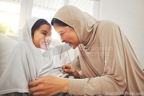 Image of Laughing, play and muslim grandmother, happy child or family bond, enjoy quality time together and granny tickle girl. Lounge sofa, funny or Islamic grandma, youth kid or playing people laugh at home