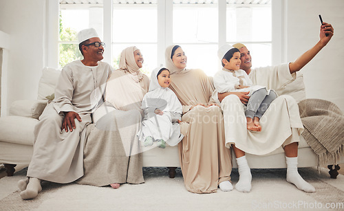 Image of Selfie, Islam and big family on sofa with smile, grandparents and parents with kids in Arab home. Portrait of Muslim men, women in hijab and happy children, generations in sitting on couch together.