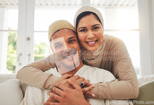 Image of Portrait, Islam and happy couple hug on couch with smile, culture and love in home in Turkey. Face of Muslim man, woman in hijab and happiness in marriage on sofa, together in respect and religion.