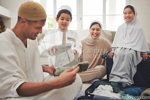 Image of Eid, packing and a Muslim family in a house for a holiday, or vacation preparation together. Happy, talking and Islamic parents with young children and a suitcase for clothes, travel or hajj