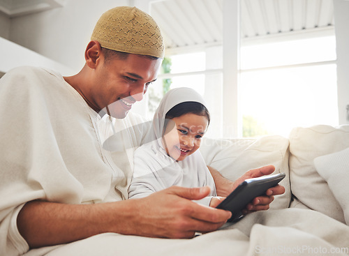 Image of Family, tablet or study with a father and muslim girl on a sofa in the living room of their home together for e learning. Kids, education or child development with a man teaching his student daughter