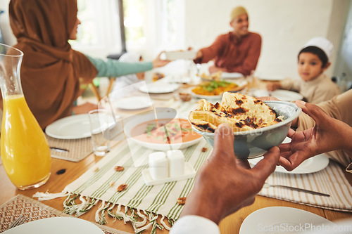 Image of Food, roti and muslim with hands of family at table for eid mubarak, Islamic celebration and lunch. Ramadan festival, culture and iftar with closeup of people at home for fasting, islam or religion