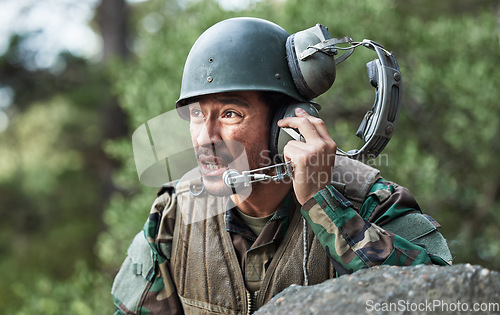 Image of Army, battle and a man with a headset for communication in a field, help or call for danger. Veteran, hero and a person in the military with gear for support, talking or advice in nature for safety