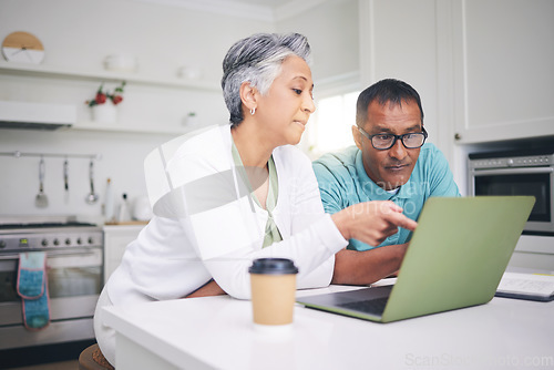 Image of Mature couple, laptop and pointing for internet connection, communication or social media post. A man and woman talking at home while together for online streaming, search or email with technology