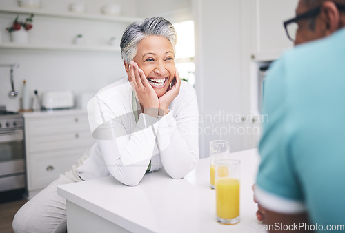 Image of Senior couple, love and conversation in kitchen with juice for quality time or happy in retirement. Smile, marriage and elderly woman or man with beverage in home for bonding on weekend or to relax.