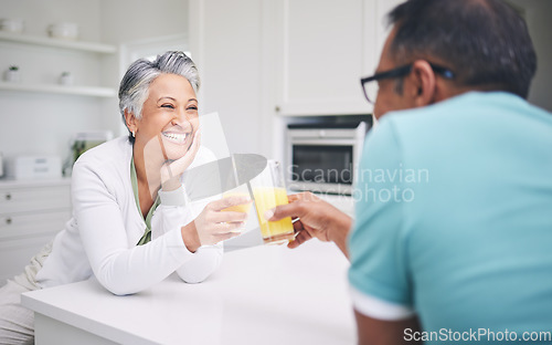 Image of Senior couple, smile and cheers in a kitchen with toast and love celebration drink. Home, juice and cocktail together of elderly man and woman happy of support and care with marriage and anniversary