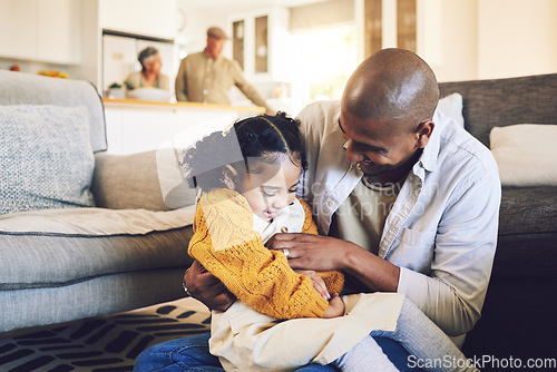 Image of Family, happy and father with girl child on a living room floor playing, laugh and bond in their home together. Love, hug and kid with parent in a lounge for tickle, fun and games on the weekend