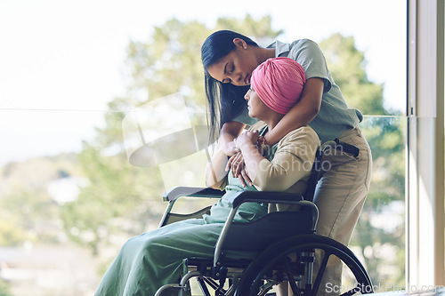 Image of Senior mother, woman and hug with wheelchair, love and care with bonding, kindness and nursing home. Girl, embrace and elderly person with disability for support, empathy or trust by window at clinic