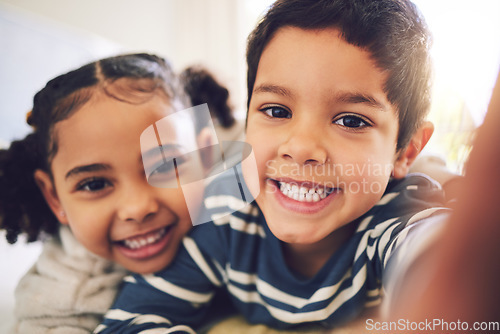 Image of Children, girl and brother with selfie, portrait or smile in home for hug, care and bonding together. Happy sibling kids, photography and profile picture for social media, blog and memory in house