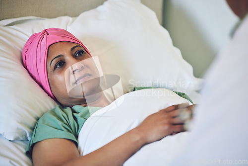 Image of Medical, healthcare and cancer with muslim woman in bed at hospital for treatment or recovery. Islam, medicine or sad person in hospice with a sick or tired mature patient in clinic for chemotherapy