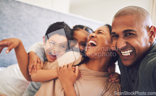 Image of Family, laughing together and parents with children at home, fun and comedy with people bonding and love in bedroom. Happiness, man and woman with kids, funny and carefree, playful and relax at house