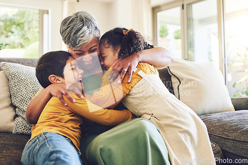 Image of Hug, grandma or happy kids on a sofa with love enjoying quality bonding time together in family home. Smile, affection or senior grandmother relaxing with young children siblings on house couch