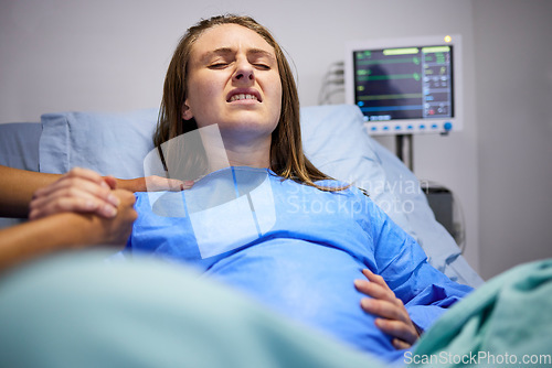 Image of Pregnant woman, hospital and delivery with push, holding hands and support in bed, baby and pain. Strong mother, labor and helping hand in clinic bed for infant child, motivation and new life