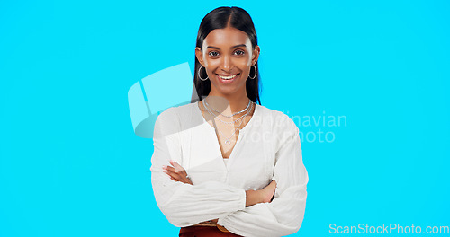 Image of Face, proud and business woman in studio, happy and empowered against blue background space. Portrait, leader and indian lady entrepreneur motivated for startup, goal or career while posing in power