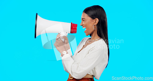 Image of Megaphone, voice and announcement of woman isolated on blue background broadcast, breaking news and loud opinion. Indian person with speaker sound for gen z lifestyle or call to action sign in studio