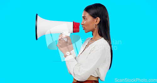 Image of Megaphone, voice and announcement of woman isolated on blue background broadcast, breaking news and loud opinion. Indian person with speaker sound for gen z lifestyle or call to action sign in studio