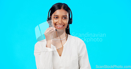 Image of Call center, funny or laughing woman in studio for communication on blue background mockup. Friendly customer services, crm or. Indian girl in headset helping, talking or explaining for tech support