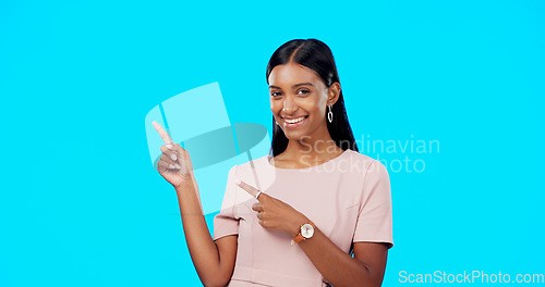 Image of Mock up, happy studio or woman point at sales promotion, present gift or discount deal mockup. Female portrait, advertising space or marketing product placement for person isolated on blue background