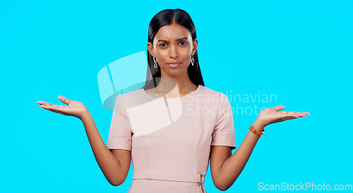 Image of Choice, option or decision and a woman on a blue background in studio with a hand gesture. Portrait, balance and scale with an attractive young female weighing up the pros and cons of a variable