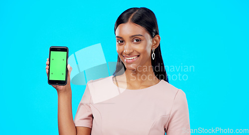 Image of Chroma key, green screen and woman holding phone with mockup for logo, branding and mobile app advertising. Smile, happy and portrait of professional female isolated in a studio blue background