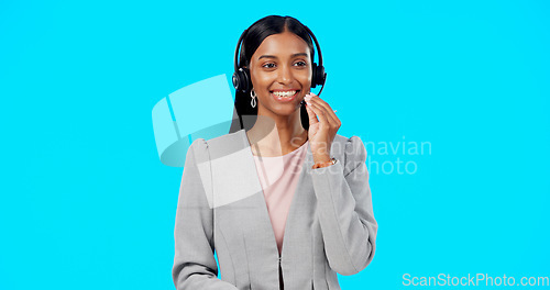 Image of Call center, crm or Indian woman in studio for communication isolated on blue background. Customer services, mockup or friendly girl in headset helping, talking or explaining at technical support