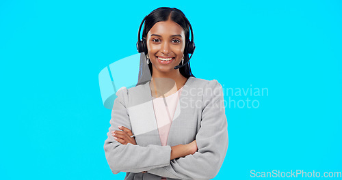 Image of Call center, portrait or Indian woman in studio for communication isolated on blue background. Face smile, mockup or friendly girl in headset helping at technical support, telecom or customer service