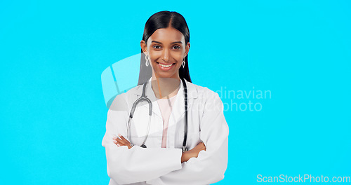 Image of Studio woman, confidence and happy doctor, female surgeon or nurse for support, medical healthcare or health. Medicine professional pride, cardiology portrait and hospital person on blue background