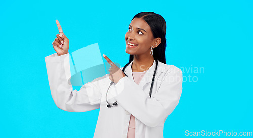 Image of Healthcare doctor, studio and happy woman point at medical promotion, hospital notification or clinic announcement mockup. Nurse portrait, advertising surgeon and marketing person on blue background
