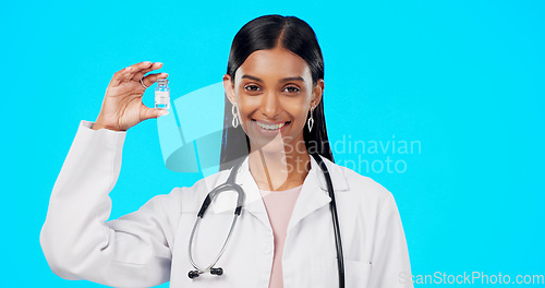Image of Studio woman, vaccine and happy doctor, female surgeon or nurse with covid 19, monkeypox or disease cure. Medical portrait, medicine bottle container or science hospital innovation on blue background