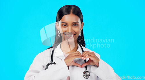 Image of Heart gesture, happy woman and medical doctor, surgeon or nurse care for support, medicine healthcare or cardiology health. Emoji love sign, studio portrait or hospital female help on blue background