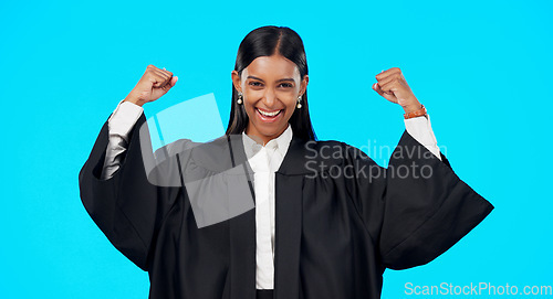 Image of Woman, bicep muscle celebration and studio with excited face for legal victory for smile by blue background. Judge, lawyer or indina law expert in portrait to celebrate winning court case by backdrop